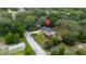 An aerial shot shows the home's tranquil location and spacious yard surrounded by lush trees at 7330 Canal Dr, Sanford, FL 32771