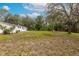 Large backyard featuring a well maintained lawn, trees, and wooden fence at 7330 Canal Dr, Sanford, FL 32771