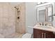 Bathroom featuring a standing shower, single sink vanity, and tiled walls at 7330 Canal Dr, Sanford, FL 32771