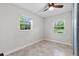 Bright bedroom featuring tile floor, ceiling fan and two large windows at 7330 Canal Dr, Sanford, FL 32771