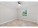 Bedroom featuring neutral walls, tile floor, ceiling fan, and a bright window at 7330 Canal Dr, Sanford, FL 32771