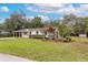 Single-story home featuring a large front yard and landscaping at 7330 Canal Dr, Sanford, FL 32771