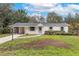 Charming single story home featuring a car port, manicured front lawn, and walkway at 7330 Canal Dr, Sanford, FL 32771