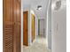 Hallway with tile flooring, wood doors and trim at 7330 Canal Dr, Sanford, FL 32771