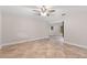 Spacious living room with tile flooring, ceiling fan, and ample natural light at 7330 Canal Dr, Sanford, FL 32771