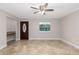 Welcoming living room featuring tile floors, a ceiling fan, and a decorative front door with sidelight at 7330 Canal Dr, Sanford, FL 32771