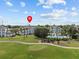 Aerial view of condo buildings surrounded by green golf course and lush landscaping at 7615 Heritage Crossing Way # 201, Reunion, FL 34747