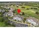 Aerial view of condo buildings near a golf course and pool, indicating a desirable location at 7615 Heritage Crossing Way # 201, Reunion, FL 34747