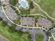 Aerial shot of condos, golf course, and community pool, showcasing the attractive surroundings at 7615 Heritage Crossing Way # 201, Reunion, FL 34747