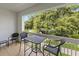 Serene balcony featuring outdoor seating and a picturesque view of mature trees at 7615 Heritage Crossing Way # 201, Reunion, FL 34747