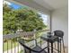 Charming balcony with outdoor seating offers serene views of the lush landscape at 7615 Heritage Crossing Way # 201, Reunion, FL 34747