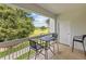 Relaxing balcony with seating offers a peaceful view of the lush golf course at 7615 Heritage Crossing Way # 201, Reunion, FL 34747