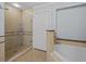 Modern bathroom features tiled shower and separate soaking tub at 7615 Heritage Crossing Way # 201, Reunion, FL 34747
