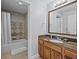 Bathroom featuring a large mirror, vanity with granite countertop, and a separate shower and tub at 7615 Heritage Crossing Way # 201, Reunion, FL 34747