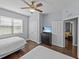 Cozy bedroom featuring two beds, a ceiling fan, and a dresser with a TV at 7615 Heritage Crossing Way # 201, Reunion, FL 34747