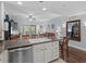 Open floor plan: Kitchen with granite countertops and a breakfast bar overlooking the living room at 7615 Heritage Crossing Way # 201, Reunion, FL 34747