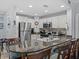 Kitchen with a granite countertop island with seating, stainless steel appliances, and white cabinetry at 7615 Heritage Crossing Way # 201, Reunion, FL 34747
