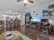 Open concept living room featuring hardwood floors and access to the kitchen and balcony at 7615 Heritage Crossing Way # 201, Reunion, FL 34747