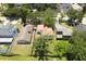 Overhead view of home with mature tree coverage and an orange-shingled roof at 7939 Winter Song Dr, Orlando, FL 32825