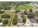 Aerial view of property near a green space, water retention area and roadways at 7939 Winter Song Dr, Orlando, FL 32825