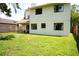 Spacious backyard showcasing lush green grass, mature trees, and a covered patio, great for outdoor activities at 7939 Winter Song Dr, Orlando, FL 32825