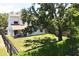 Spacious backyard featuring a lush lawn, mature trees, and a cozy patio area for outdoor enjoyment at 7939 Winter Song Dr, Orlando, FL 32825