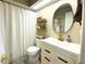 Elegant bathroom with modern fixtures, a white vanity, and cozy decor for a spa-like experience at 7939 Winter Song Dr, Orlando, FL 32825