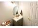 Stylish powder room featuring a modern vanity, oval mirror, and fresh, minimalist design at 7939 Winter Song Dr, Orlando, FL 32825