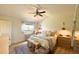 Inviting bedroom with a cozy bed, hardwood floors, and natural light, creating a relaxing retreat at 7939 Winter Song Dr, Orlando, FL 32825