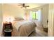 Bright bedroom with a plush bed, natural light streaming through the window, and hardwood floors at 7939 Winter Song Dr, Orlando, FL 32825