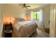 Cozy bedroom featuring warm lighting, a comfortable bed, and light wood flooring, creating a relaxing ambiance at 7939 Winter Song Dr, Orlando, FL 32825