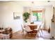 Bright dining room with a round table, modern chairs, and large window overlooking the backyard at 7939 Winter Song Dr, Orlando, FL 32825