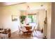 Sunlit dining room with modern lighting, wood floors, and a view of the outdoor landscape at 7939 Winter Song Dr, Orlando, FL 32825