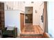 Inviting entryway with natural light, warm wood floors, and a convenient coat rack at 7939 Winter Song Dr, Orlando, FL 32825