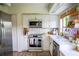 Updated kitchen boasts modern appliances, white cabinets, and ample counter space at 7939 Winter Song Dr, Orlando, FL 32825