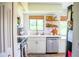 Well-lit kitchen with updated appliances, white cabinetry, and open shelving that add charm at 7939 Winter Song Dr, Orlando, FL 32825