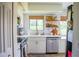 Well-lit kitchen features stainless steel appliances, white cabinets, and a large window at 7939 Winter Song Dr, Orlando, FL 32825