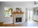 Bright living room with a stone fireplace, a large window, and sliding glass doors to the backyard at 7939 Winter Song Dr, Orlando, FL 32825