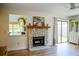 Charming living room with stone fireplace, sliding glass doors, and hardwood floors at 7939 Winter Song Dr, Orlando, FL 32825