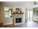 Living room features a stone fireplace, sliding glass doors, and a view into the kitchen at 7939 Winter Song Dr, Orlando, FL 32825