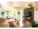 This cozy living room boasts wood floors and a media center wall, perfect for relaxation and entertaining at 7939 Winter Song Dr, Orlando, FL 32825