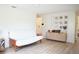 Spacious living room with a white futon, light wood floors and a gallery wall at 7939 Winter Song Dr, Orlando, FL 32825
