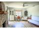 Bright living room with stone fireplace, a desk area, and comfortable seating at 7939 Winter Song Dr, Orlando, FL 32825