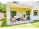 Inviting covered patio with comfortable seating and a ceiling fan, perfect for outdoor relaxation at 7939 Winter Song Dr, Orlando, FL 32825