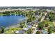 Breathtaking aerial view of neighborhood homes nestled along a serene lakefront, offering stunning water views and lush greenery at 840 Bethune Dr, Orlando, FL 32810