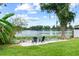 Inviting backyard with chairs on a sand area with lake view, perfect for relaxing near the water at 840 Bethune Dr, Orlando, FL 32810