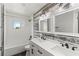 Updated bathroom features double sinks, new fixtures, and subway tile shower surround at 840 Bethune Dr, Orlando, FL 32810