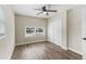 This bedroom has wood-look floors, double door closet, and a ceiling fan at 840 Bethune Dr, Orlando, FL 32810