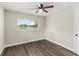 Bedroom with wood-look floors, a ceiling fan, and view of the lake at 840 Bethune Dr, Orlando, FL 32810