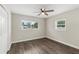 This bedroom features wood-look flooring, closet with double doors, and a ceiling fan at 840 Bethune Dr, Orlando, FL 32810